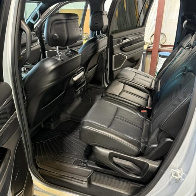 Clean detailed SUV back seat with spotless leather and floor mats after interior detailing in Southwest Florida