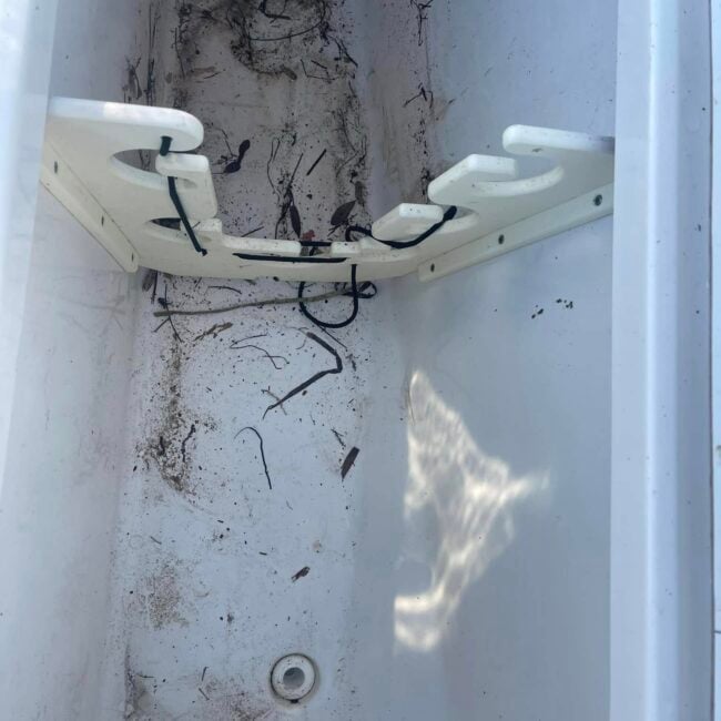Dirty boat storage locker with debris and grime before deep cleaning and marine detailing in Southwest Florida