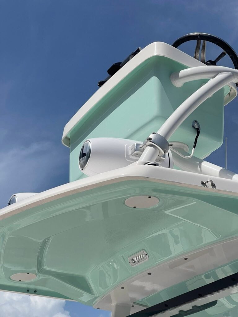 Seafoam green center console boat helm and hardtop polished to a high gloss against blue sky in Southwest Florida